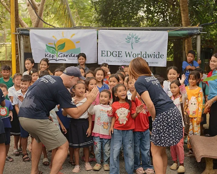 EDGE Worldwide and Kep Gardens staff greeting students in Cambodia