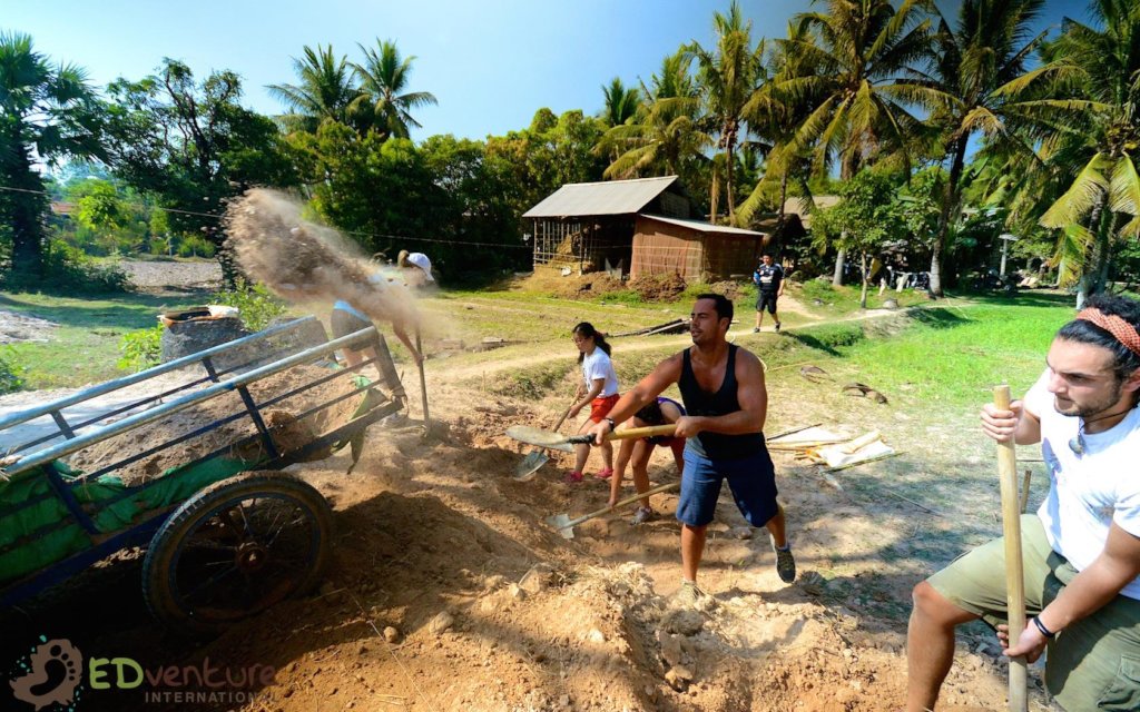 Volunteers and community members digging foundations for the Phum Ou community school, early work of EDGE Worldwide, a Cambodia educational charity