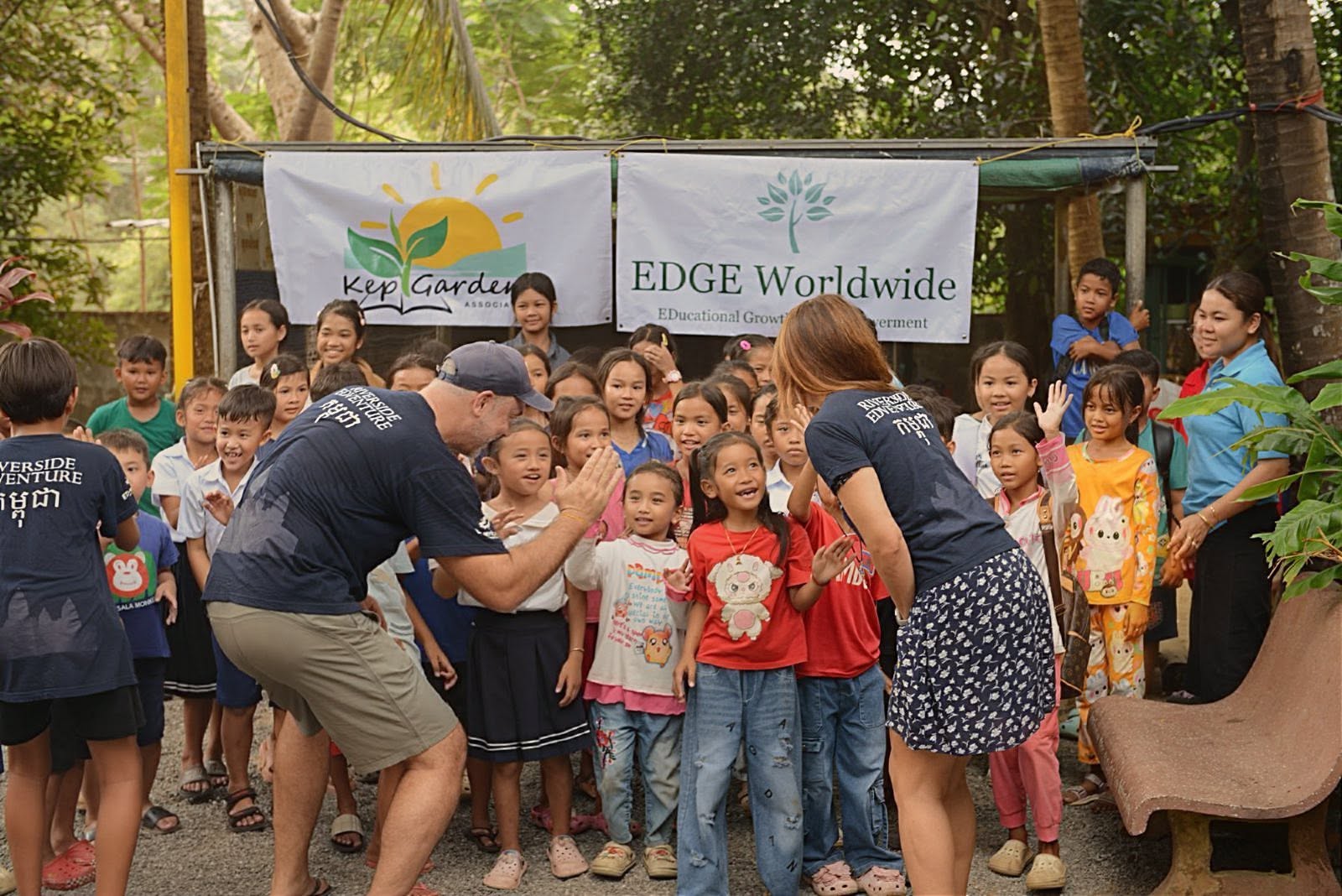 EDGE Worldwide and Kep Gardens Association staff greeting students in Cambodia