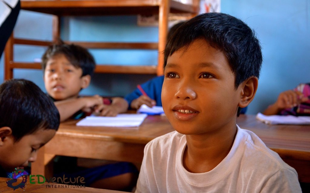A Cambodian boy continuing his studies in class, the kind of pathway EDGE Worldwide scholarships keep open
