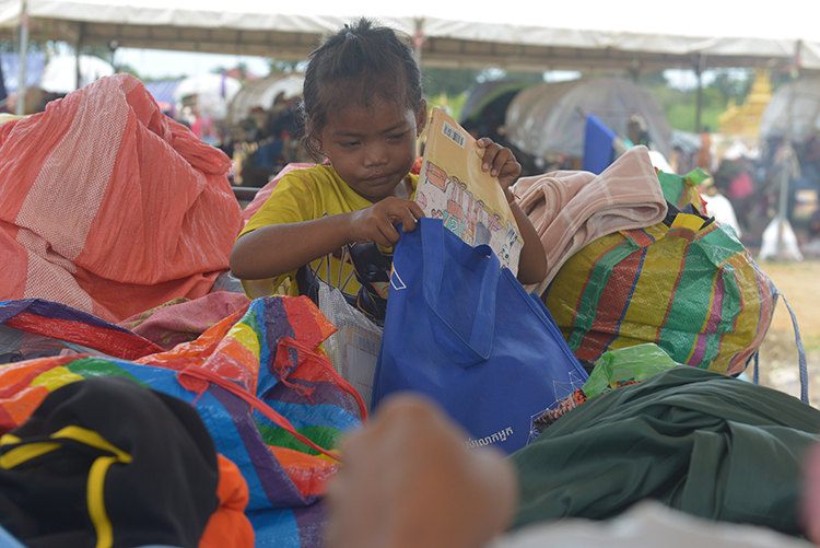 Displaced Cambodian children receive EDGE Worldwide supply packages at a shelter near the northern border