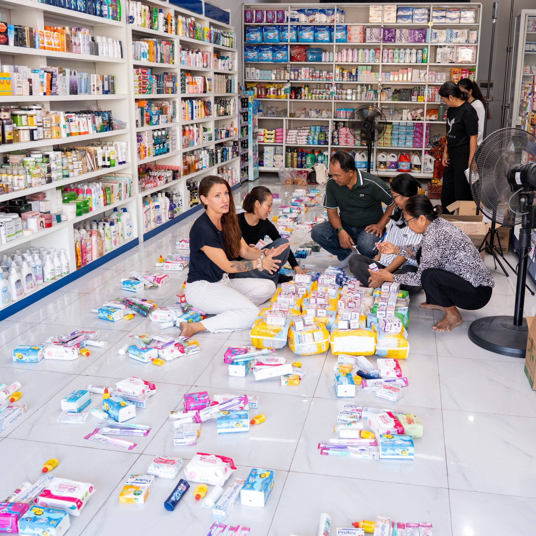 EDGE Worldwide volunteers assemble soap, toothbrushes and personal care items into family relief packages in Cambodia