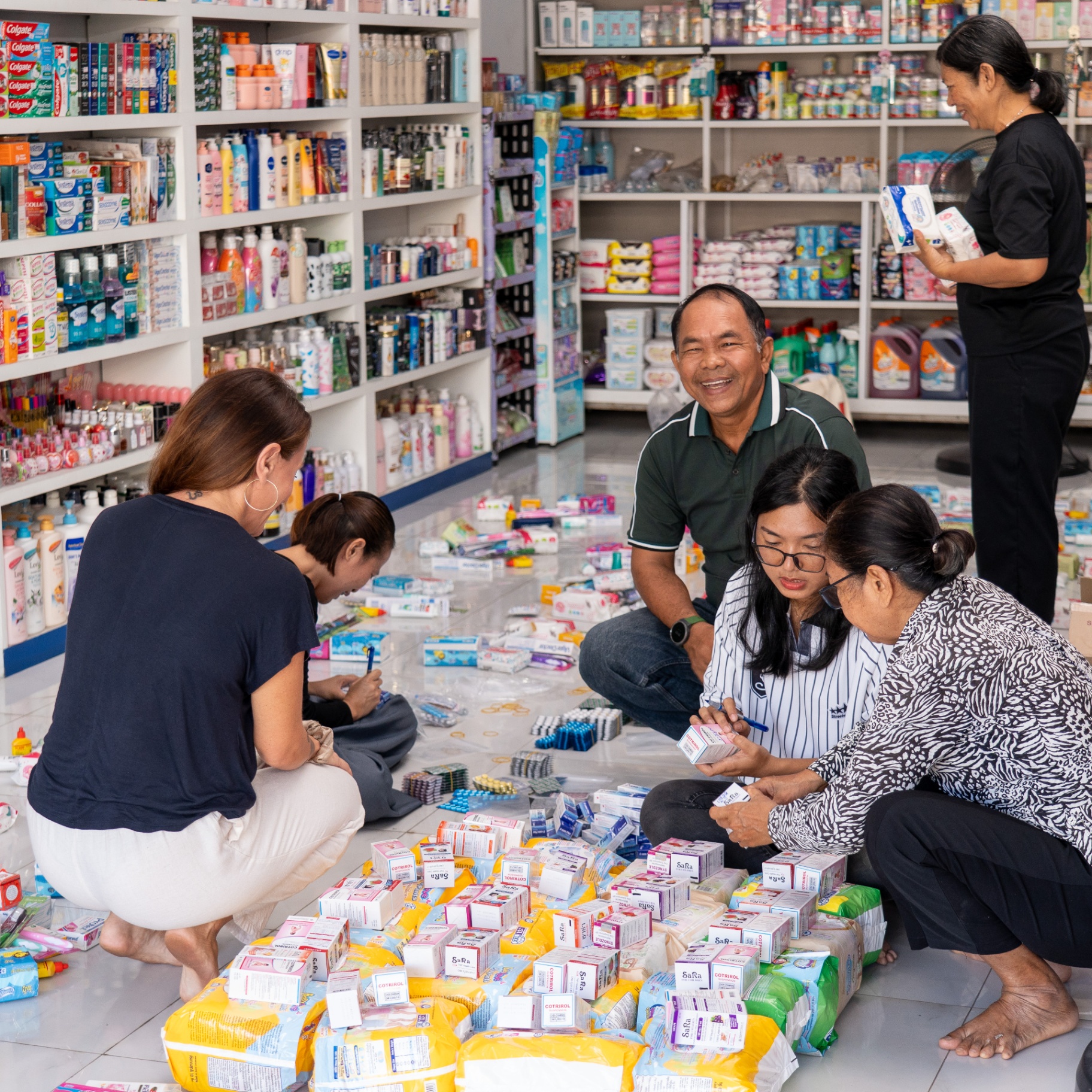 Community volunteers working alongside EDGE Worldwide to prepare relief essentials in Cambodia