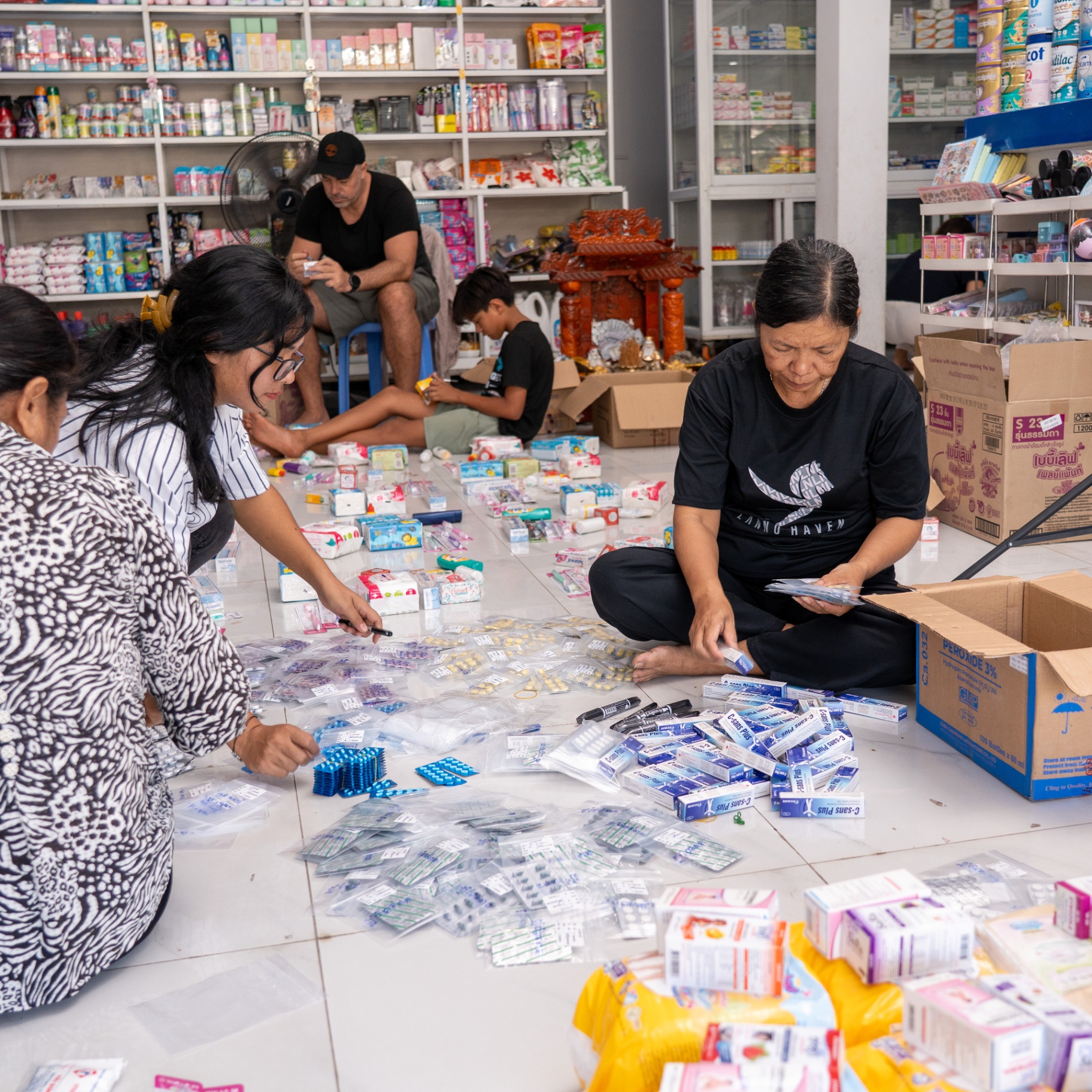 EDGE Worldwide volunteers sort and re-bag donated medicine for the Cambodia border crisis relief effort