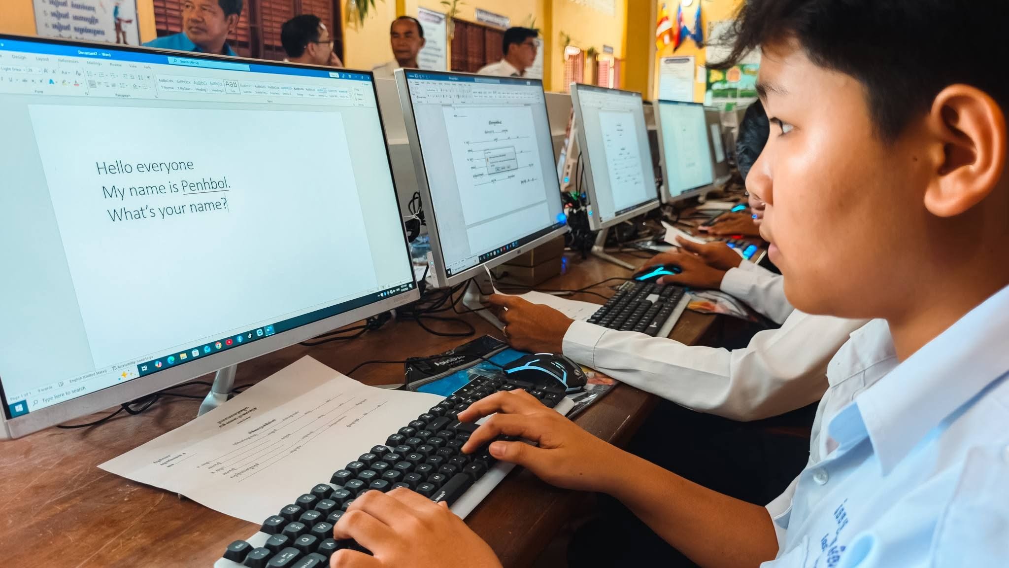 A student typing at a computer in the new IT lab