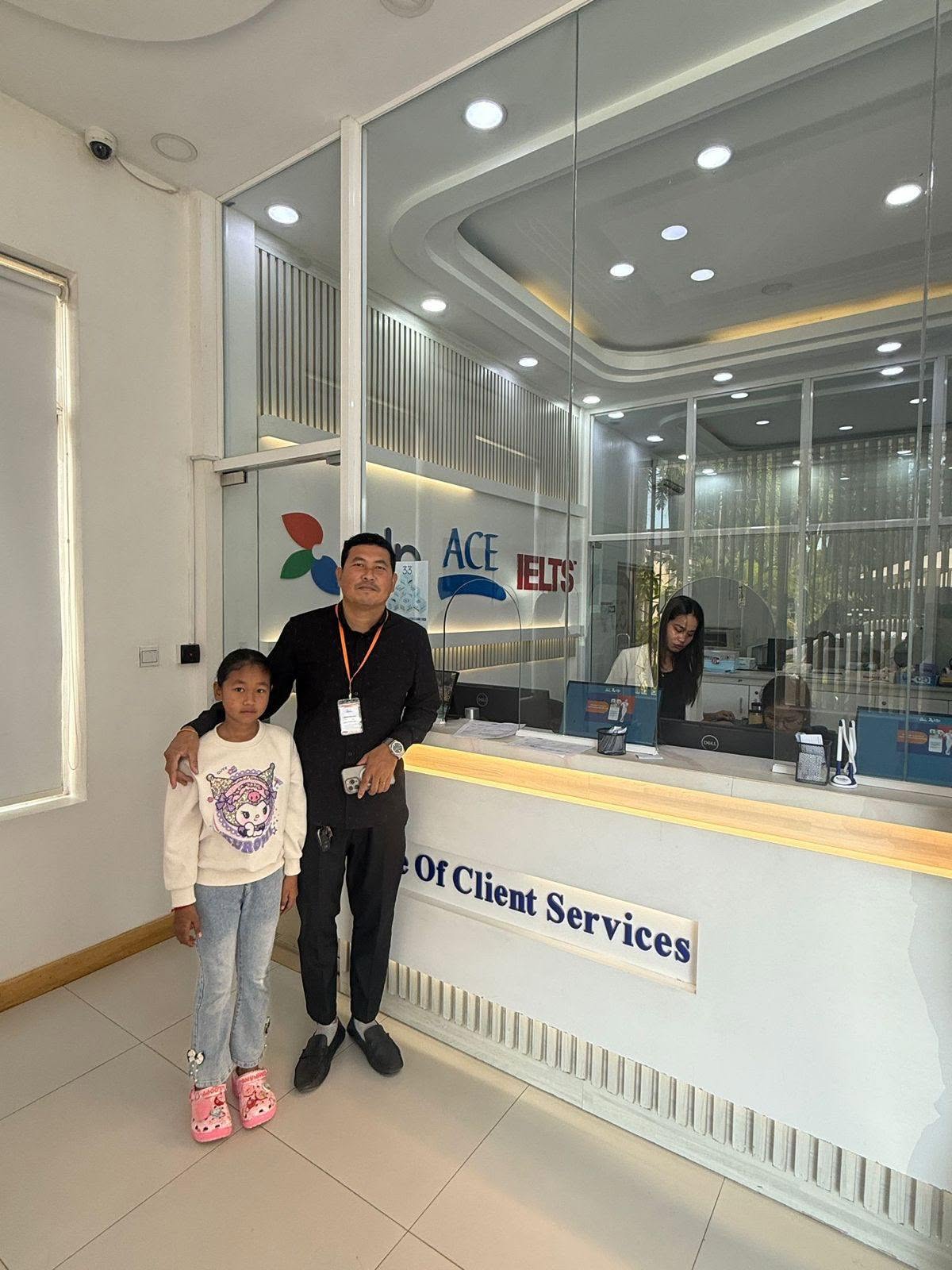 Hongda and Seavhong beside the reception desk at the Australian Centre for Education.