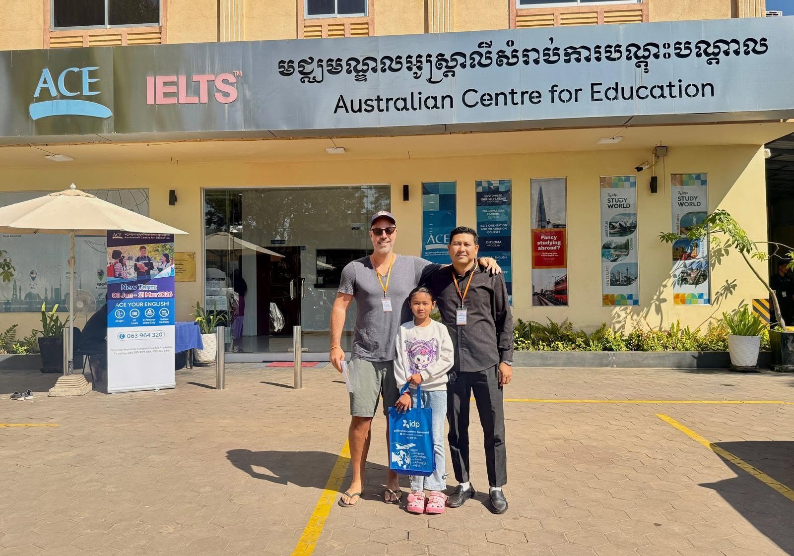 Jamie Christopherson with Hongda and his daughter Seavhong outside the Australian Centre for Education.
