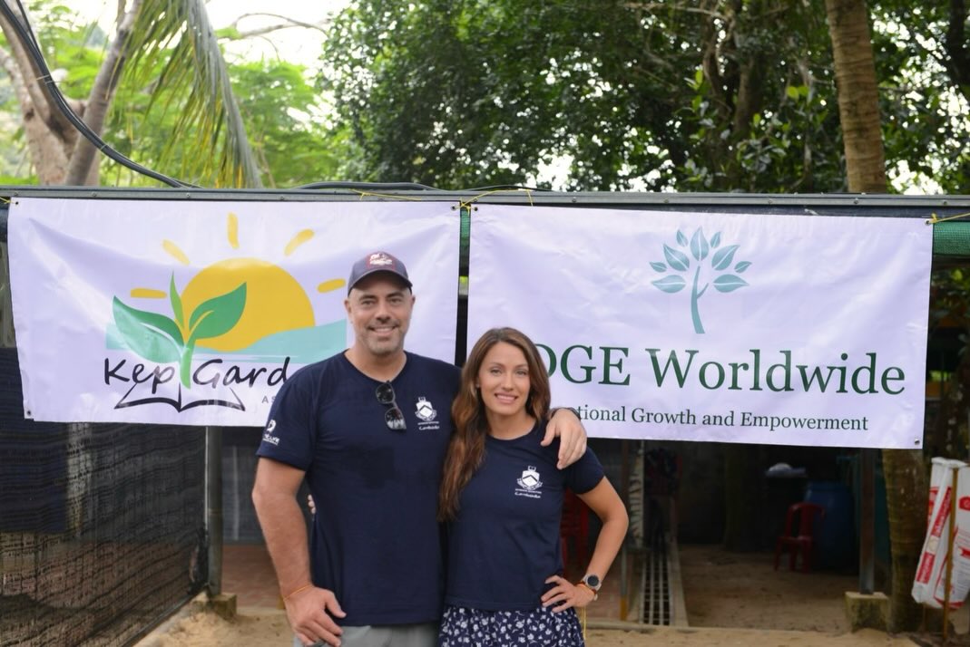 Jamie Christopherson and Hilde Marie Kvaløsæter standing in front of the Kep Gardens and EDGE Worldwide banners.